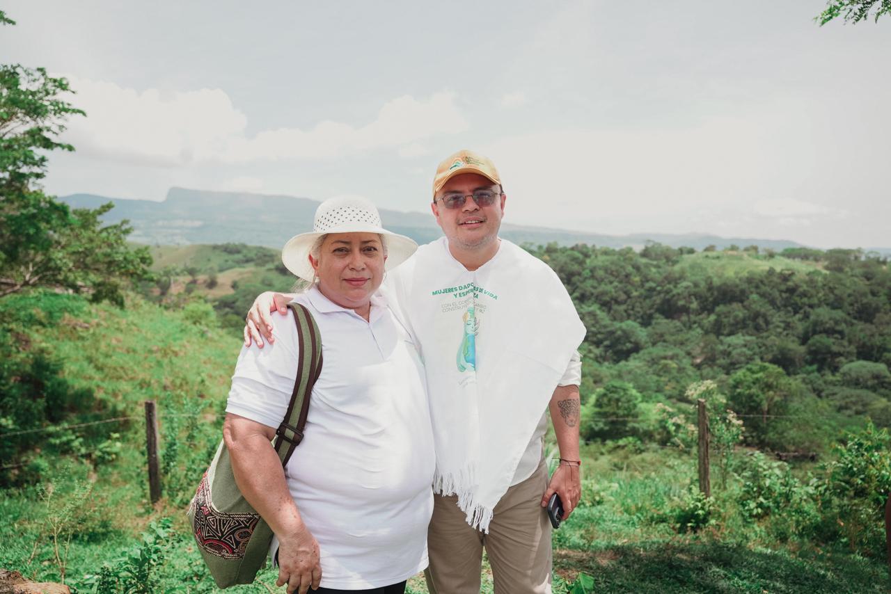 dos-hombres-parados-frente-a-una-colina-verde